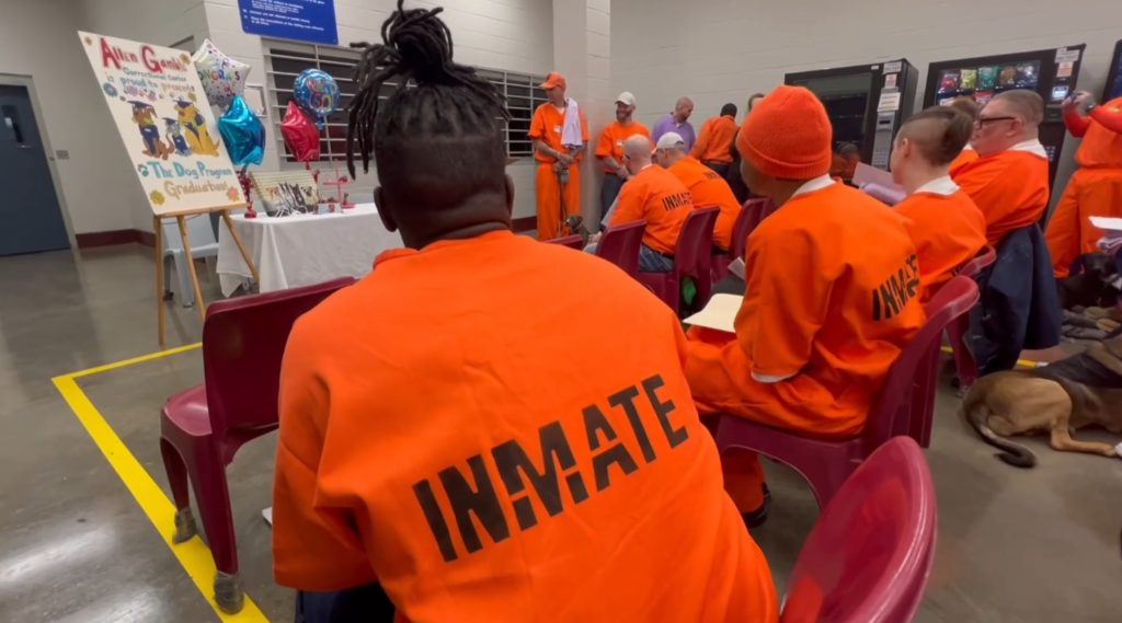 PenPals prison dog program graduation with inmates and shelter dogs in Holdenville, Oklahoma